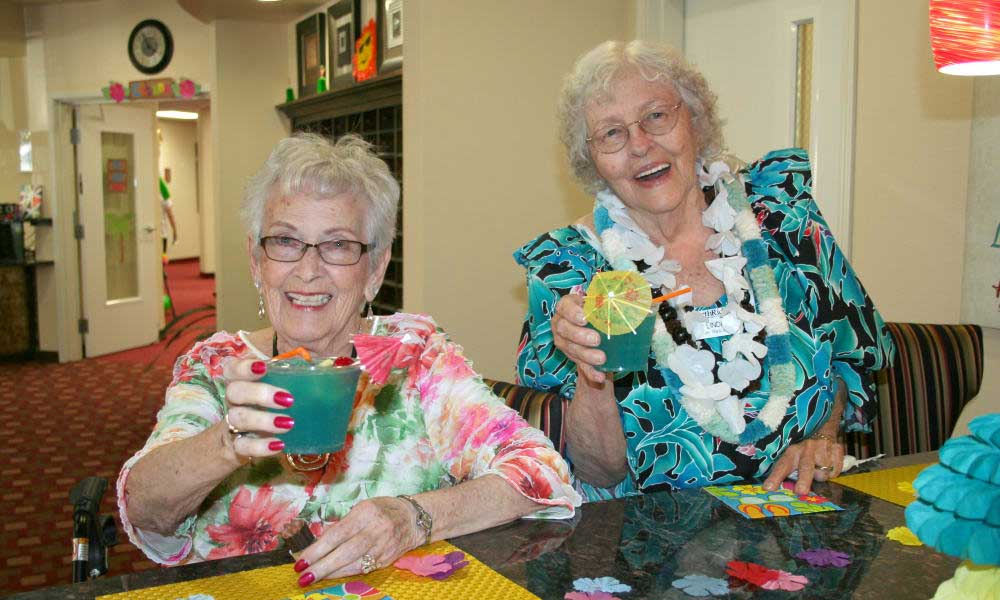 Ashton Gardens friends toasting drinks playing bingo