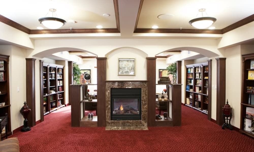 Camden Springs common area with fireplace and bookcases