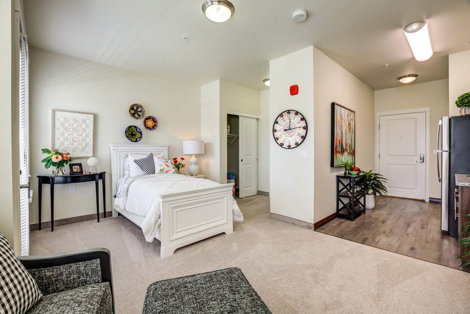 Hawthorn Senior Living. Camellia Gardens. Senior Apartment with Bed and Kitchen.