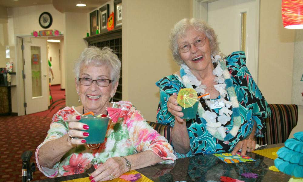 Hawthorn Senior Living. Colonial Gardens Senior Residents Playing Bingo with Hawaiian Shirts On.