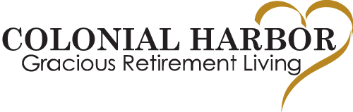 Colonial Harbor logo featuring the text "Colonial Harbor Gracious Retirement Living" in black font, accompanied by a stylized gold heart on the right side.