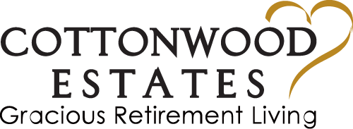 The image features the logo for Cottonwood Estates, a retirement living community. The text reads "COTTONWOOD ESTATES Gracious Retirement Living" with a stylized heart shape incorporated into the word "ESTATES.