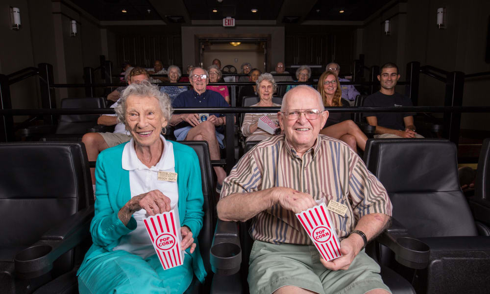 Senior couple eating popcorn at the movies