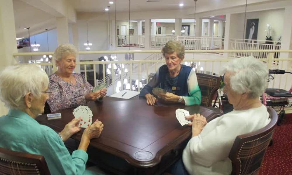 Senior residents playing cards at a table