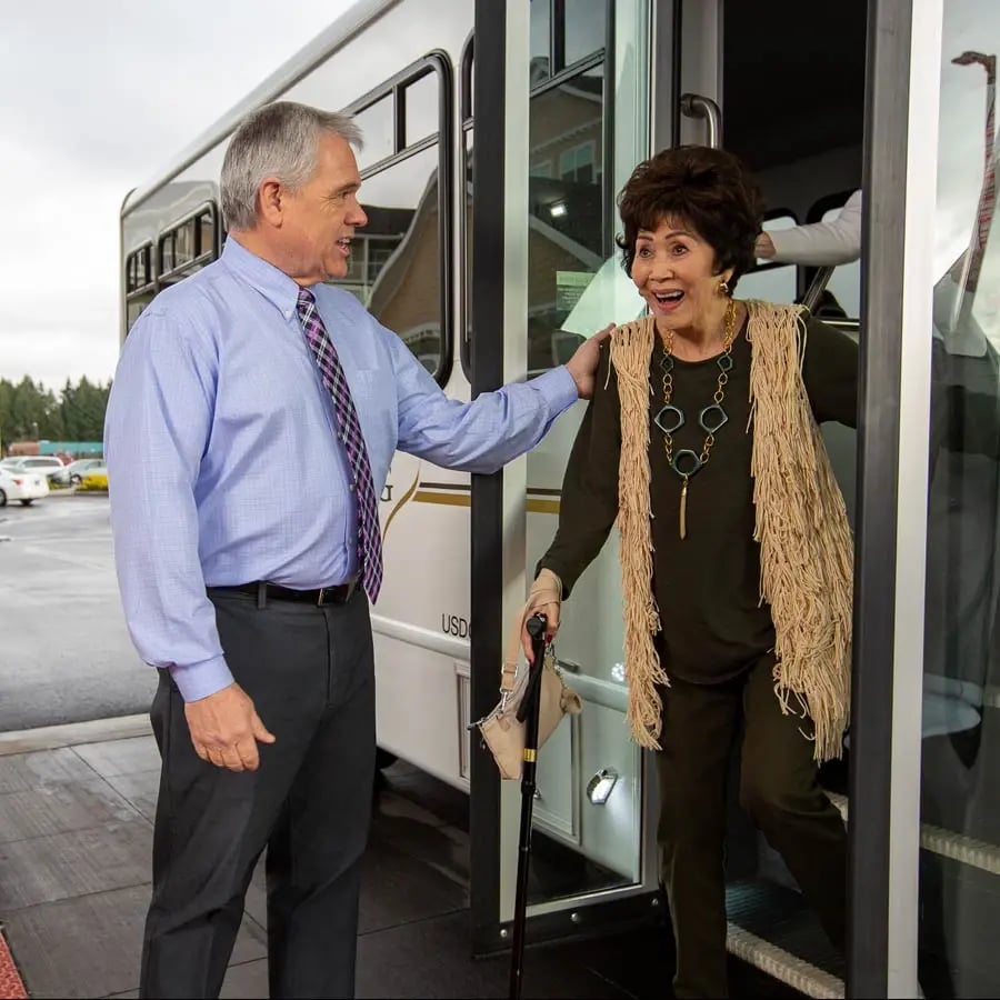 man-helping-lady-off-bus