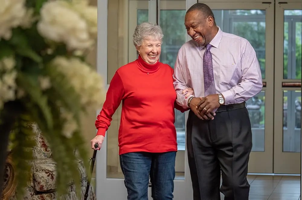 Senior man and woman walking down hall
