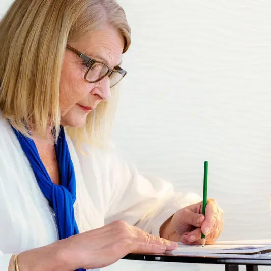 senior-writing-desk-indoors-journal-e1717698856746