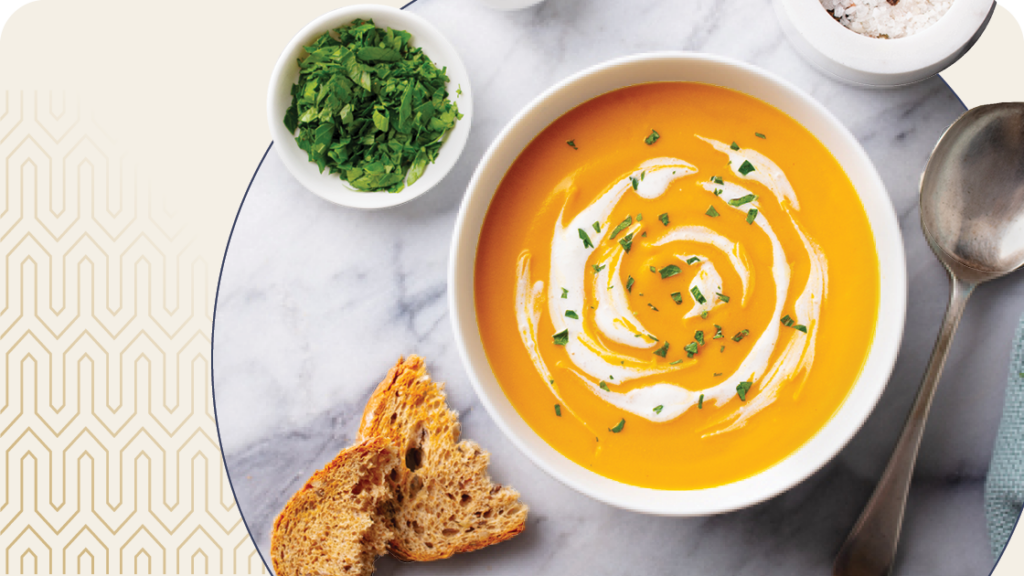 Squash soup with bread on a plate