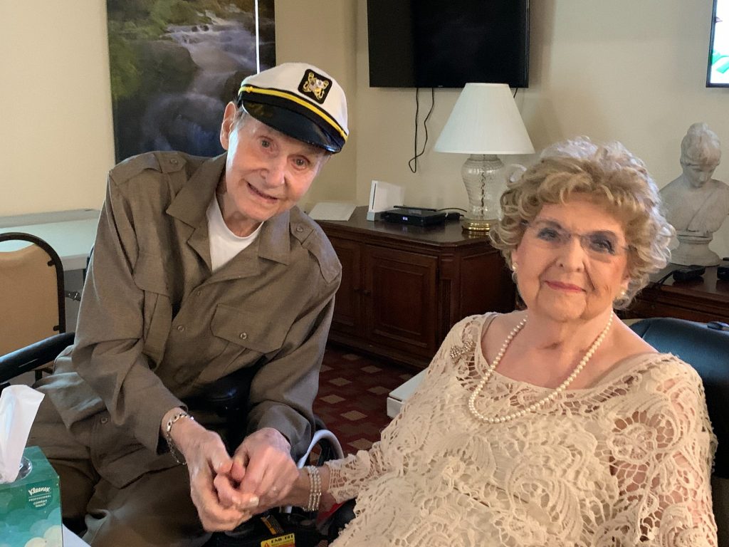 Senior resident holding females hand