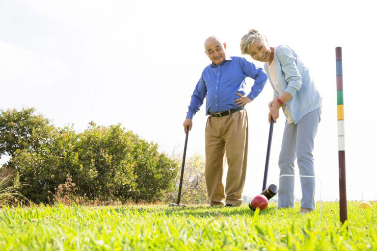 Seniors playing Croquet in the yard