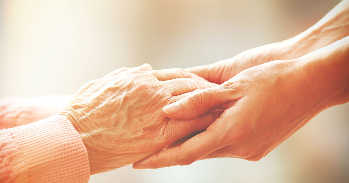 Senior and young hands holding each other