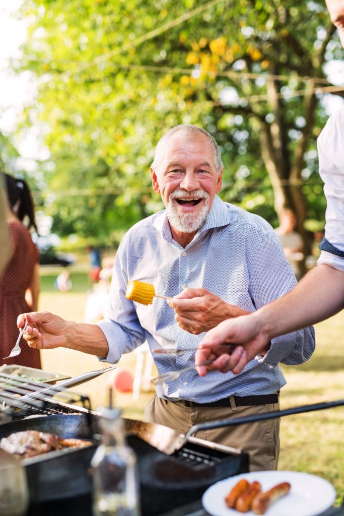 Resident eating bbq outside at grill