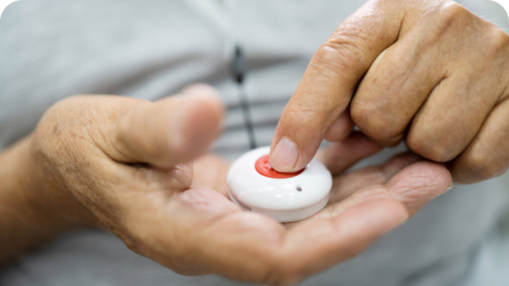 senior hands pressing safety alert button