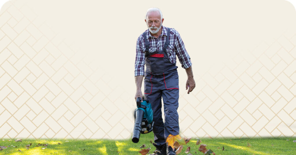 Senior man using a leaf blower