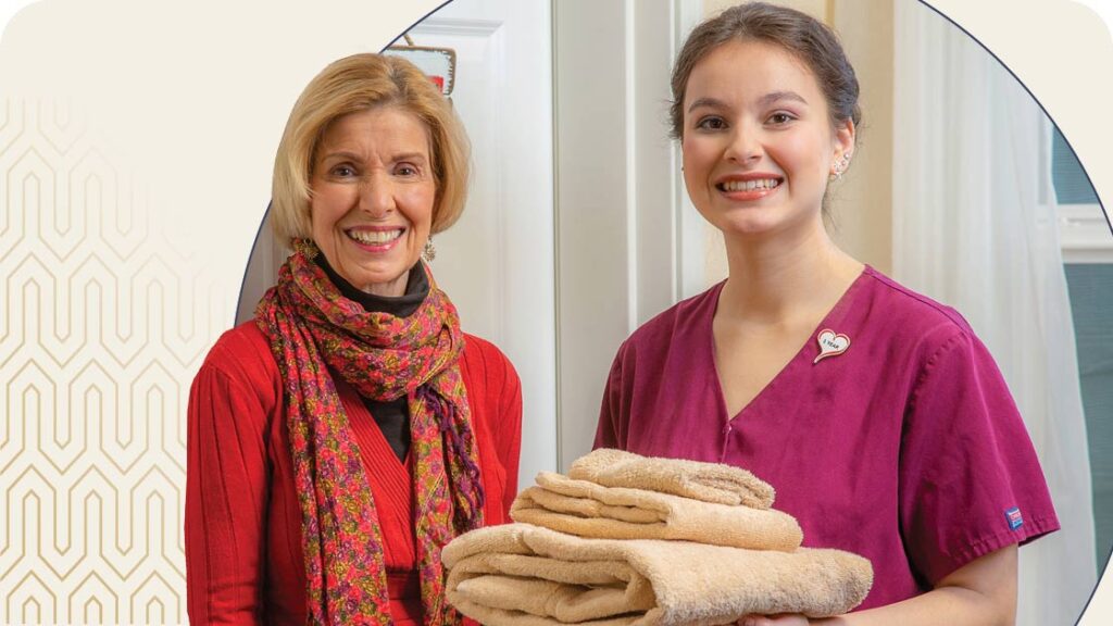 senior woman and female staff member smiling