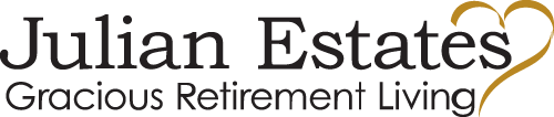Logo image for Julian Estates Gracious Retirement Living features the name "Julian Estates" in large black letters, with the phrase "Gracious Retirement Living" below in smaller black text. A stylized golden heart is incorporated into the logo design.