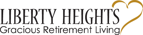 Logo for "Liberty Heights Gracious Retirement Living." The text is written in black, and a gold heart outline is positioned on the right side. The font is elegant and clear.