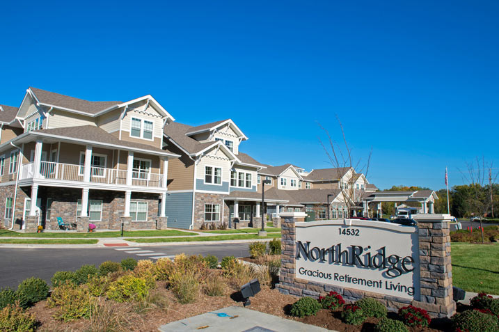 A modern, multi-story retirement community named 