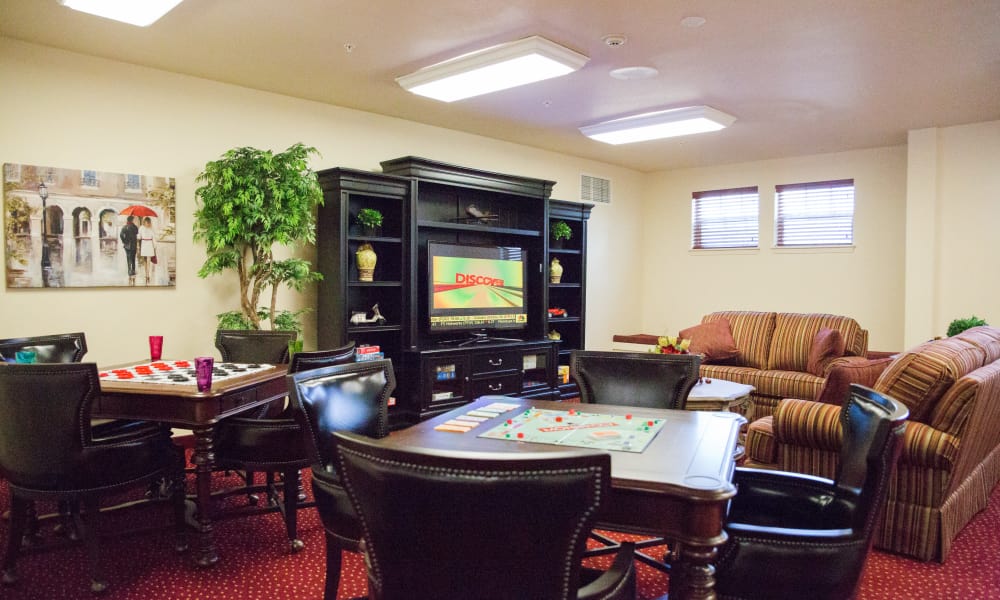 A cozy living room with a TV displaying the word 