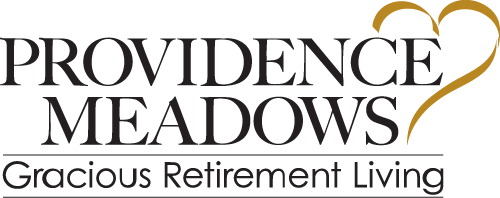 Logo of Providence Meadows with the text "Providence Meadows Gracious Retirement Living" in black. There is a yellow outline of a heart above the word "Living.