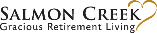 The image features a logo for "Salmon Creek Gracious Retirement Living." The text is in black, with the words "Gracious Retirement Living" in a smaller, italicized font underneath "Salmon Creek." There is a gold heart outline integrated into the design.