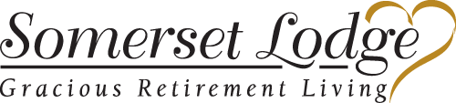 Logo of Somerset Lodge with the text "Somerset Lodge" in elegant black font. A gold heart is incorporated into the word "Lodge." Below it, the tagline "Gracious Retirement Living" is also in black text.