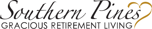 Logo for Southern Pines Gracious Retirement Living with black and yellow elegant script font. The words "Southern Pines" are prominently displayed, while "Gracious Retirement Living" appears in smaller text below. A stylized heart is incorporated into the design.