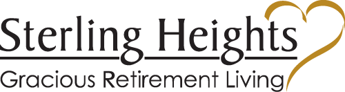 Logo of Sterling Heights Gracious Retirement Living featuring the company name in elegant black font. There is a gold outline of a heart intertwined with the text on the right side.