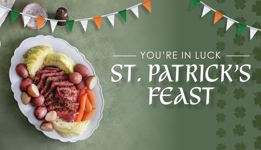 A platter of sliced corned beef, potatoes, cabbage, and carrots sits next to text that reads "You're in luck. St. Patrick's Feast" on a green background with festive bunting and shamrock patterns.