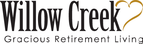 Willow Creek Gracious Retirement Living logo features the text 'Willow Creek' with a stylized golden heart forming part of the letter 'K', and the tagline 'Gracious Retirement Living' below the main text.