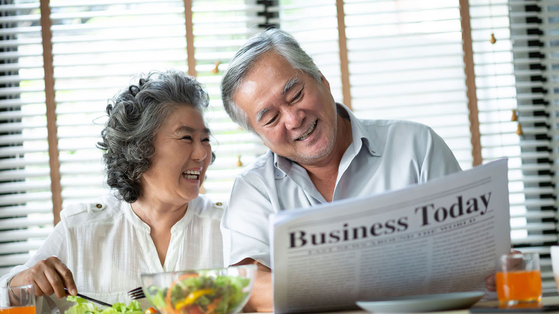 Couple looking at newspaper together