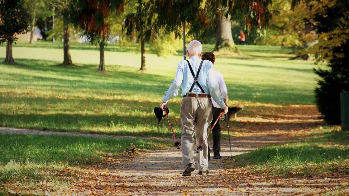 Seniors walking on dirt path in the park