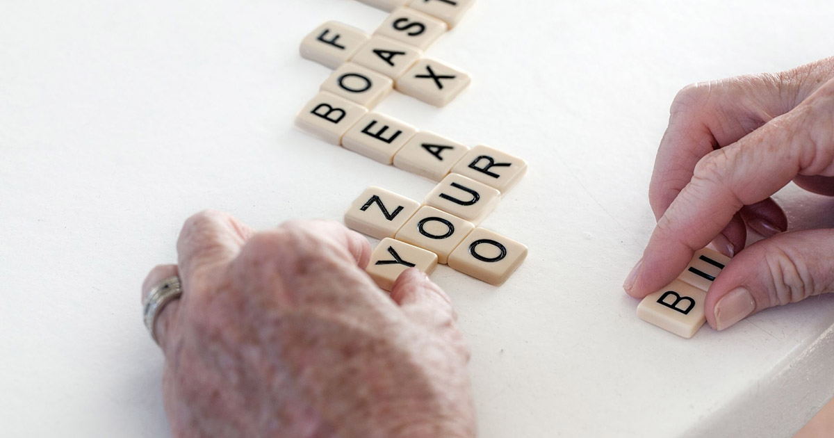 Hands playing scrabble