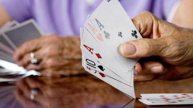 Senior woman holding cards