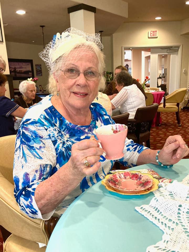 Female senior resident drinking tea