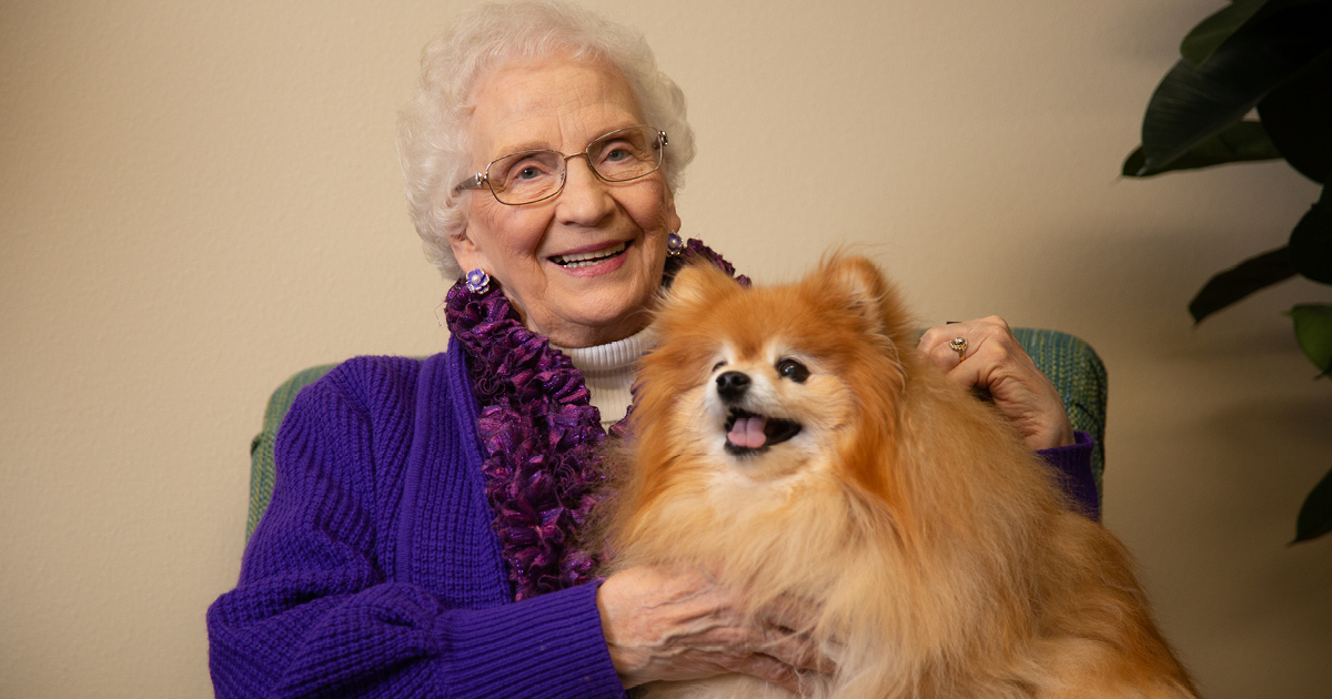 senior woman with a happy dog