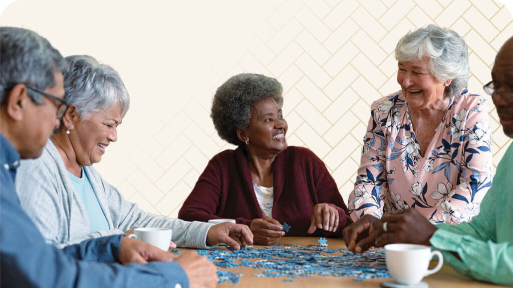 Group of seniors at a table working on a blue puzzle