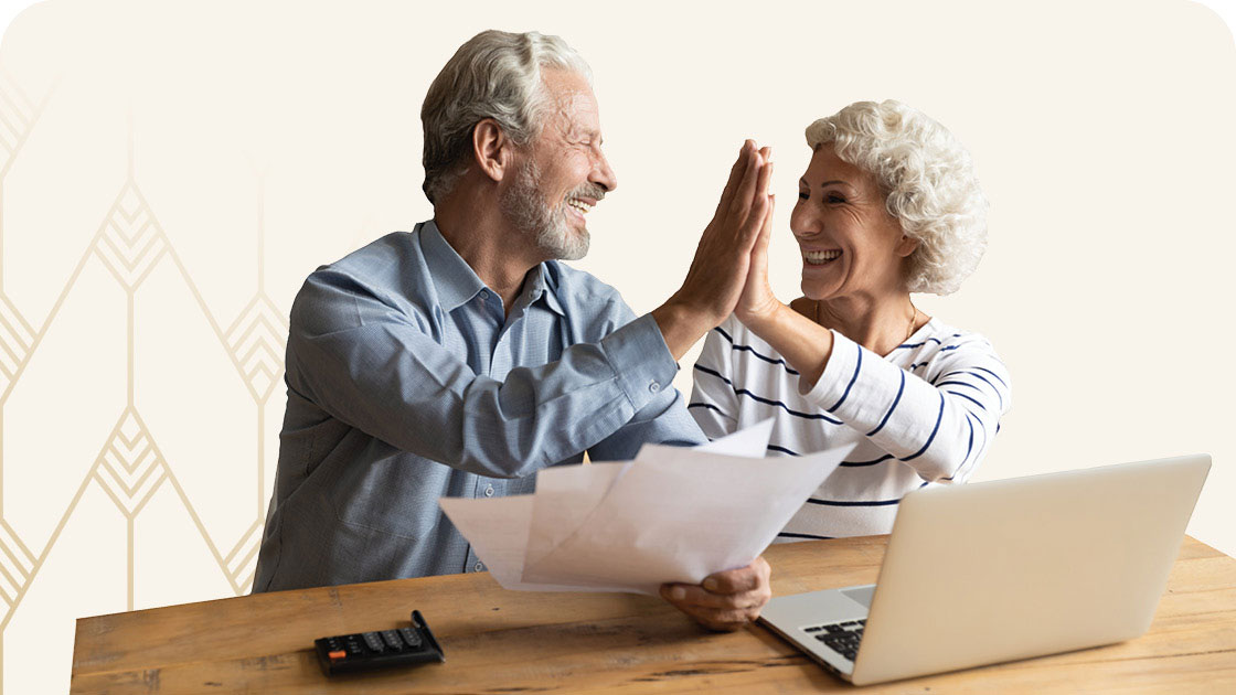 Senior couple doing a high five for saving money