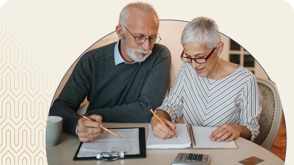Senior couple going over expenses on a table