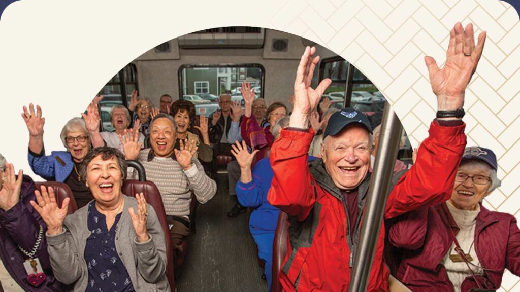 Group of seniors with hands up on a bus