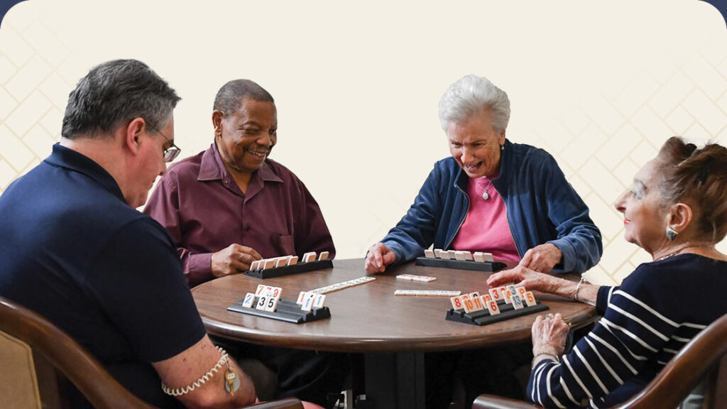 Group of seniors playing Rummikub at a table
