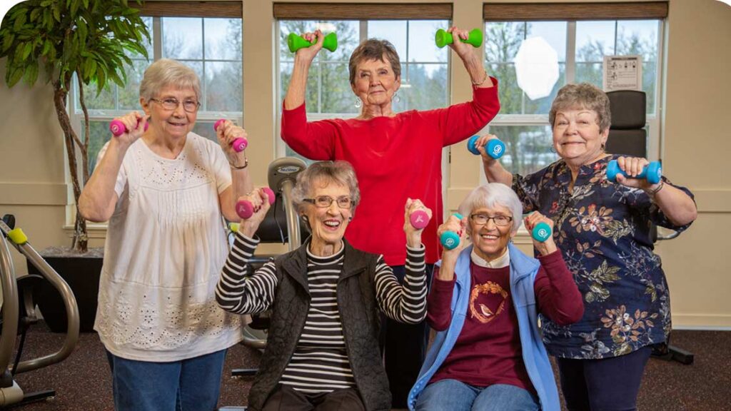Five senior women exercising with colorful dummbells