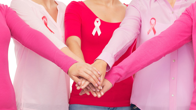Women placing hands on each other for breast cancer
