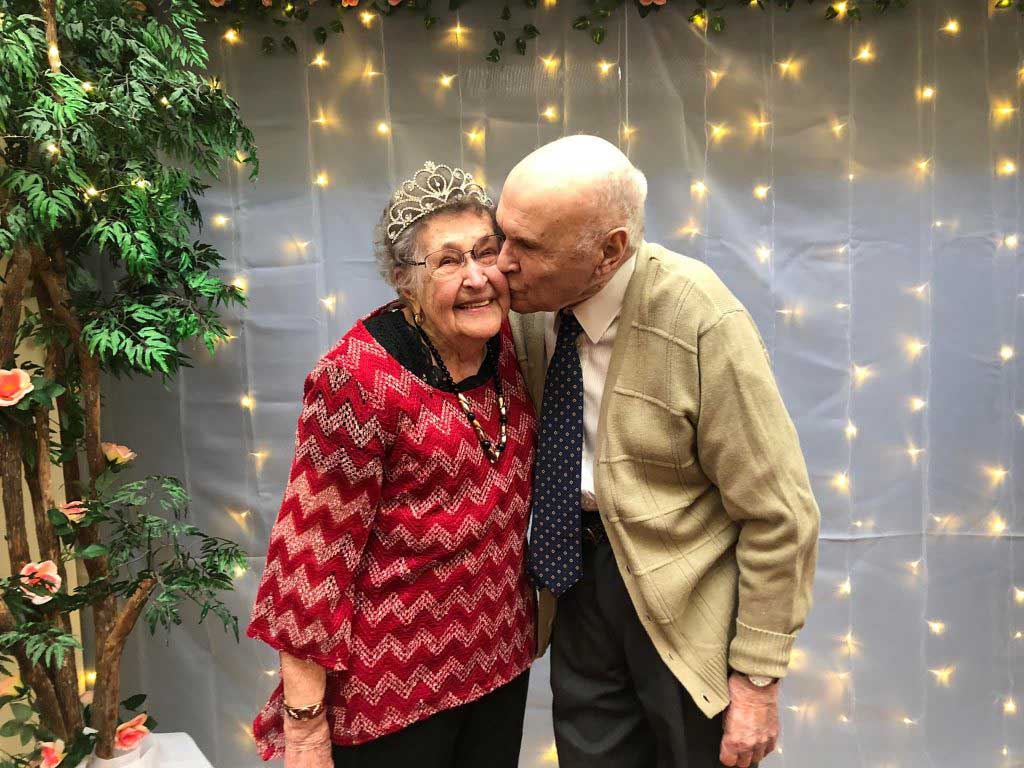 Senior couple, male kissing on cheek
