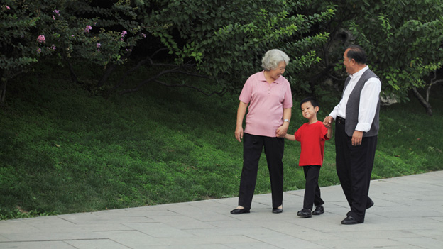 Senior couple walking with grandson